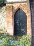 photo of wooden door in archway