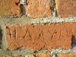 photo of etched graffiti in brickwork